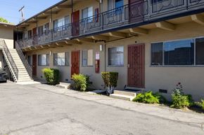Los Angeles apartment for rent - A building with a balcony and a red door.