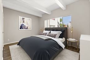 Los Angeles apartment for rent - A bedroom with a large bed and a painting on the wall.