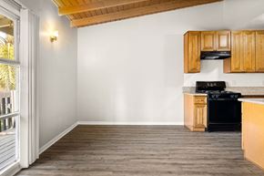 Los Angeles apartment for rent - A kitchen with wooden cabinets and a black stove top oven.