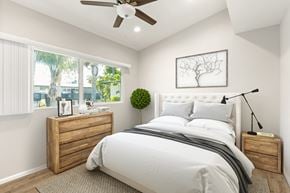 Los Angeles apartment for rent - a white bedroom with a large bed and a ceiling fan