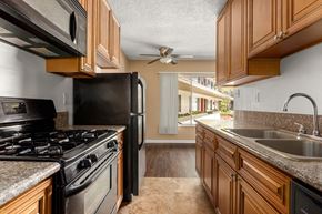 Los Angeles apartment for rent - a kitchen with a stove top oven next to a sink