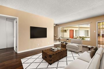 Los Angeles apartment for rent - a living room with a white couch and a television