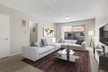 Los Angeles apartment for rent - A living room with a white couch and a world map on the wall.