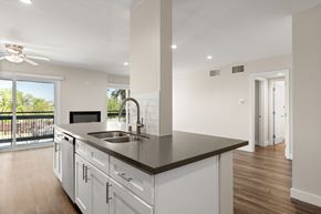 Encino apartment for rent - A modern kitchen with white cabinets and a black countertop.
