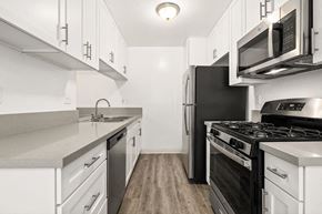 Los Angeles apartment for rent - Kitchen with Stainless-Steel Appliances, Spacious Countertops, and White Cabinets at Casa De Marina Apartments, California