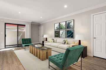 Sherman Oaks apartment for rent - A living room with a green chair and a white couch.