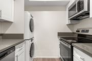 Westlake Village apartment for rent - A modern kitchen with white cabinets and stainless steel appliances.