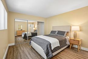 Los Angeles apartment for rent - A bedroom with a large bed and a wooden nightstand.