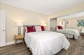 Los Angeles apartment for rent - Bedroom with White Bedding, Mirror Closet Sliding Doors, and Double Wooden at Casa De Marina Apartments, Los Angeles, CA