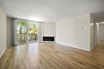 A room with wooden floors and a fireplace.