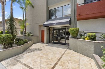 A building with a red door and a black awning