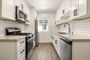 Valley Village apartment for rent - A kitchen with white cabinets and a stainless steel dishwasher.