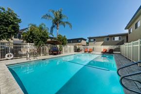 Canoga Park apartment for rent - Large Swimming Pool Surrounded by Lounge Chairs and Tables at Parthenia Terrace Apartments, Canoga Park