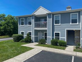 Mechanicsburg apartment for rent - A two-story building with a balcony on the second floor.