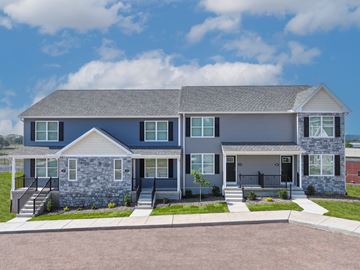 Middletown townhouse for rent - A two-story house with a grey roof and a stone foundation.