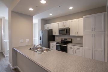 Harrisburg townhouse for rent - A kitchen with a sink, stove, and refrigerator.