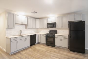 Harrisburg apartment for rent - A kitchen with black appliances and white cabinets.