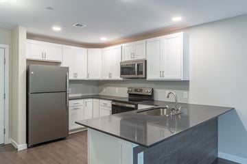 Easton apartment for rent - A kitchen with a black counter top and white cabinets.