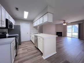 Copley apartment for rent - A modern kitchen with white cabinets and a large island.