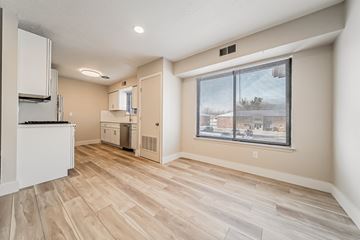 Mentor apartment for rent - A kitchen area with a refrigerator, sink, and cabinets.
