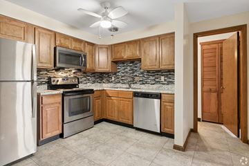 Canton apartment for rent - A kitchen with wooden cabinets and a white refrigerator.