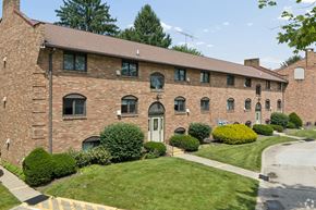 Canton apartment for rent - A large red brick building with a white door and windows.