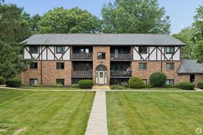 Canton apartment for rent - A large house with a black and white facade and a balcony.