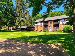 Canton apartment for rent - Large lawn in front of brick apartment building at Carriage Hill Apartments: A 55 and Better Community, Canton, OH, Ohio