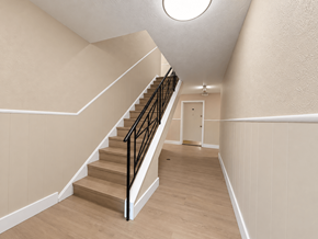 Willoughby apartment for rent - A staircase with a black railing and wooden steps.