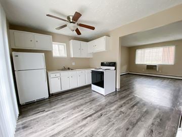 Elyria apartment for rent - an empty kitchen with white appliances and a ceiling fan