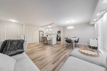 University Heights apartment for rent - A modern living room with a grey sofa and a wooden floor.