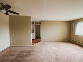 Brookpark apartment for rent - an empty living room with a ceiling fan and carpet