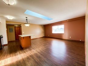 Mentor apartment for rent - an empty living room with wood floors and a table at Hallwood Manor Apartments, Mentor, OH, 44060