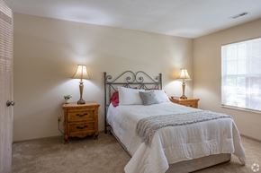 Copley apartment for rent - A bedroom with a bed, nightstands, and lamps. at Highlands of Heritage Woods Apartments, Copley