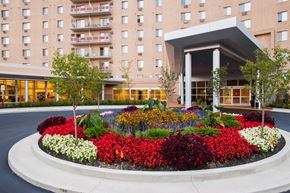 Parma apartment for rent - A flower bed in front of a building entrance at Hummingbird Pointe & The Gardens, Parma, OH 44129