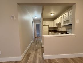University Heights apartment for rent - A kitchen with white cabinets and appliances.