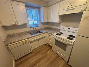 Middleburg Heights apartment for rent - A kitchen with white appliances and cabinets.