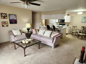 Copley apartment for rent - A living room with a grey couch and a glass coffee table.