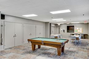 Parma Heights apartment for rent - A pool table in a room with a carpeted floor and white walls at Independence Place Apartments, Parma Heights, OH 44130