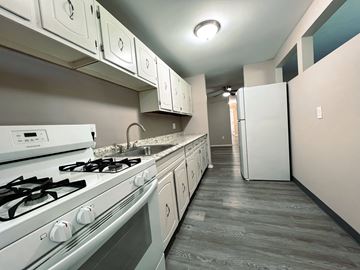 Ashland apartment for rent - a kitchen with white appliances and white cabinets and a white refrigerator