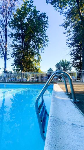 Willoughby apartment for rent - A pool with a metal ladder leading into the water.
