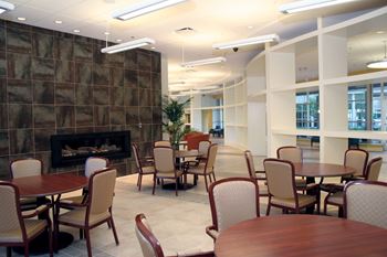 A room with a stone wall and a fireplace.