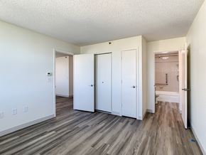 Orlando apartment for rent - a bedroom with hardwood flooring and white walls
