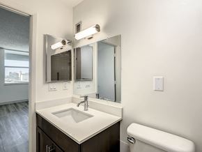 Orlando apartment for rent - a bathroom with a toilet sink and mirror