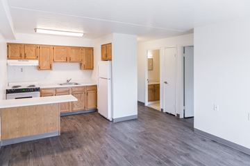 Cleveland apartment for rent - A kitchen with white appliances and wooden cabinets.