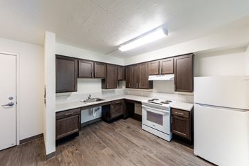Euclid apartment for rent - the preserve at ballantyne commons apartment kitchen with white appliances and dark cabinets
