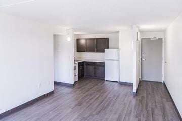 Findlay apartment for rent - A kitchen with white cabinets and a wooden floor.