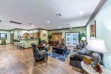 Lake Jackson apartment for rent - the living room and kitchen of a house with a couch and a table