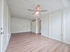 Ft Lauderdale apartment for rent - A room with a ceiling fan and wooden flooring.