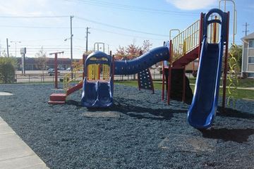 Cleveland apartment for rent - A playground with a blue slide and a yellow railing.